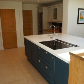 LG Hi Macs Apline white solid surface top with raised solid oak bar area