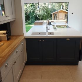 LG Hi Macs Apline white solid surface top with raised solid oak bar area